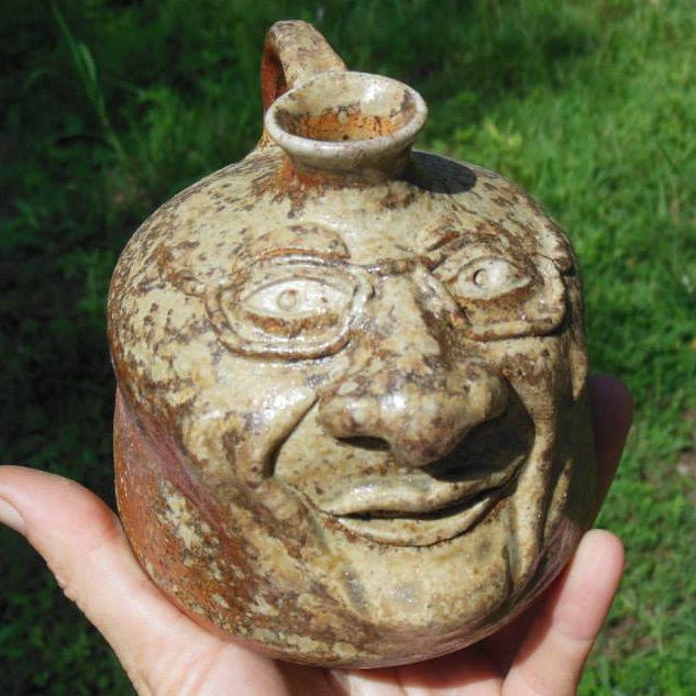Wood Fired Face Jug featuring Local Potter with eyeglasses